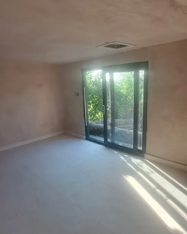 an empty room with a sliding glass door