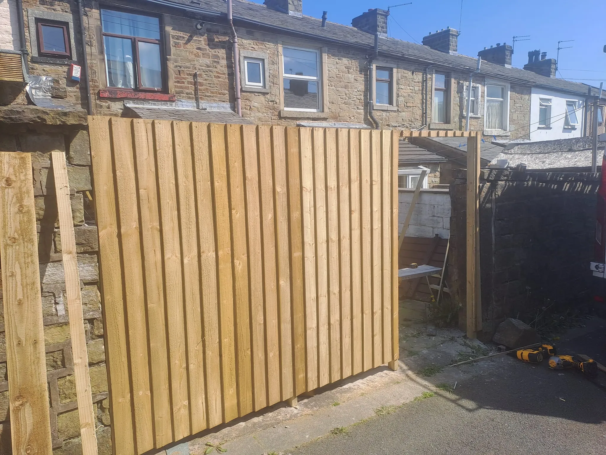 a building with a wooden fence in front of it