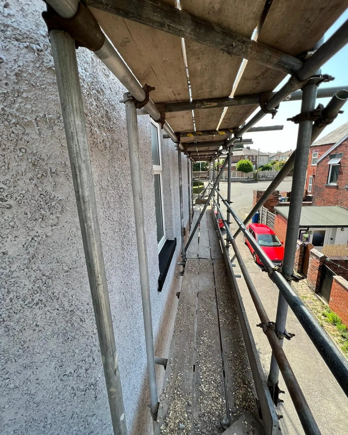 a red car parked on the side of a building