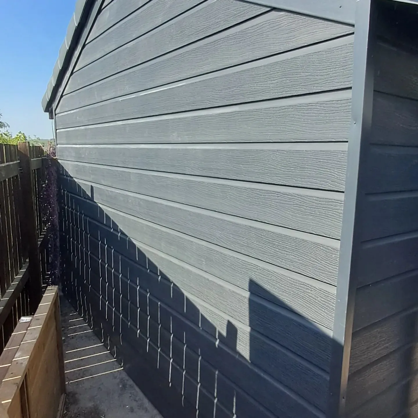 the side of a house with a wooden fence